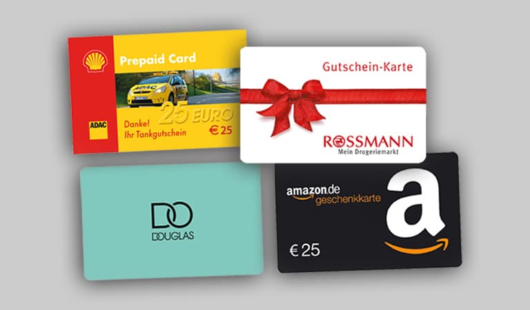Vier bunte Geschenkkarten übereinander auf grauem Hintergrund.