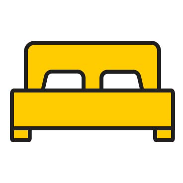 Ein gelbes Bett mit zwei weißen Kissen, klaren Linien und modernem Design